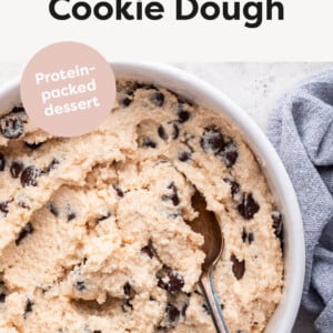 Biscuit dough with cottage cheese in a bowl with a spoon taking a tablespoon.