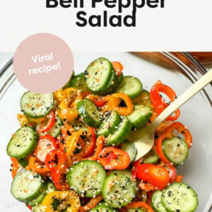 Cucumber and bell pepper salad in a transparent bowl.
