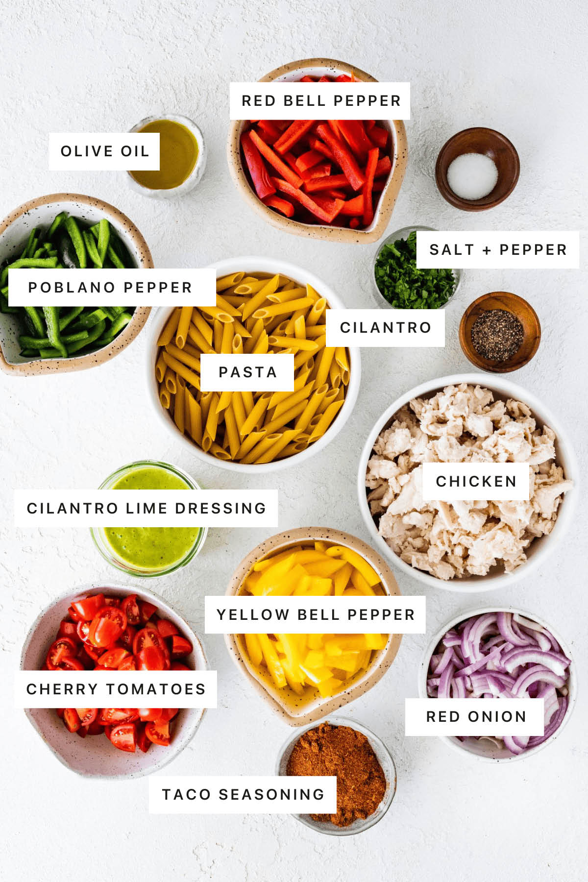 Ingredients measured out to make Chicken Fajita Pasta Salad: olive oil, red belle pepper, salt, pepper, cilantro, poblano pepper, pasta, chicken, cilantro lime dressing, yellow bell pepper, cherry tomatoes, taco seasoning and red onion.