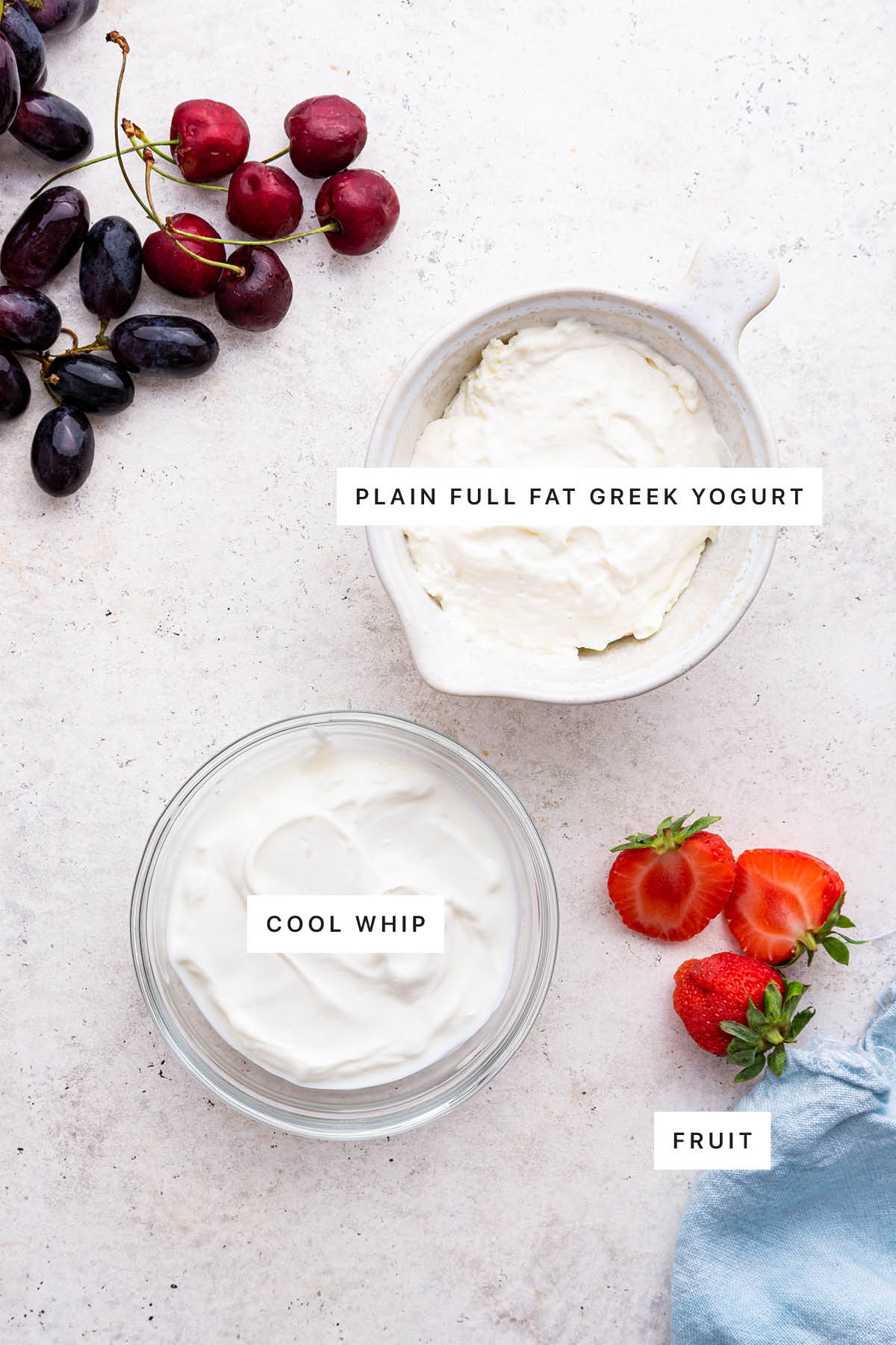 Ingredients measured out to make Yogurt Fruit Dip: greek yogurt, cool whip and fruit.