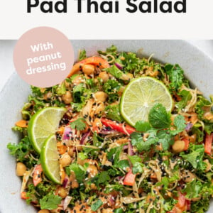 Kale & Cabbage Pad Thai Salad in a serving bowl with spoons.