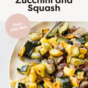 Roasted Zucchini and Squash on a plate with a serving spoon.