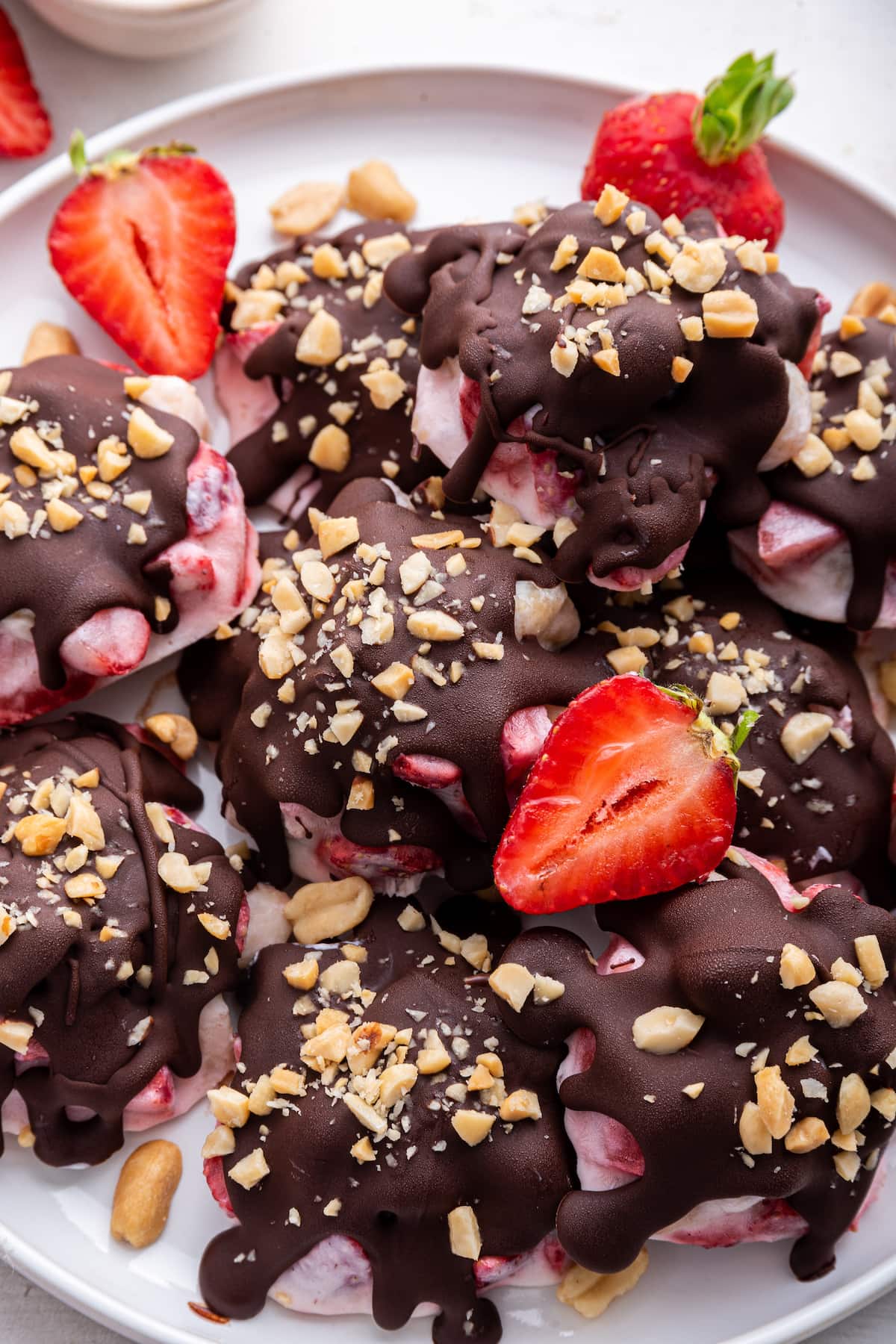 Chocolate strawberry banana yogurt clusters on a large white plate.