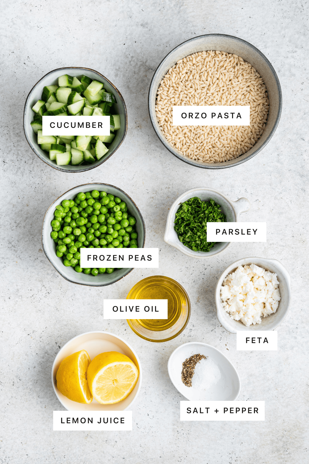 Ingredients for Lemon Orzo Salad: Orzo pasta, cucumbers, frozen peas, parsley, feta cheese, olive oil, lemon juice, salt and pepper.