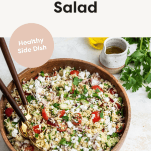 Bowl of Couscous Salad with serving spoons.