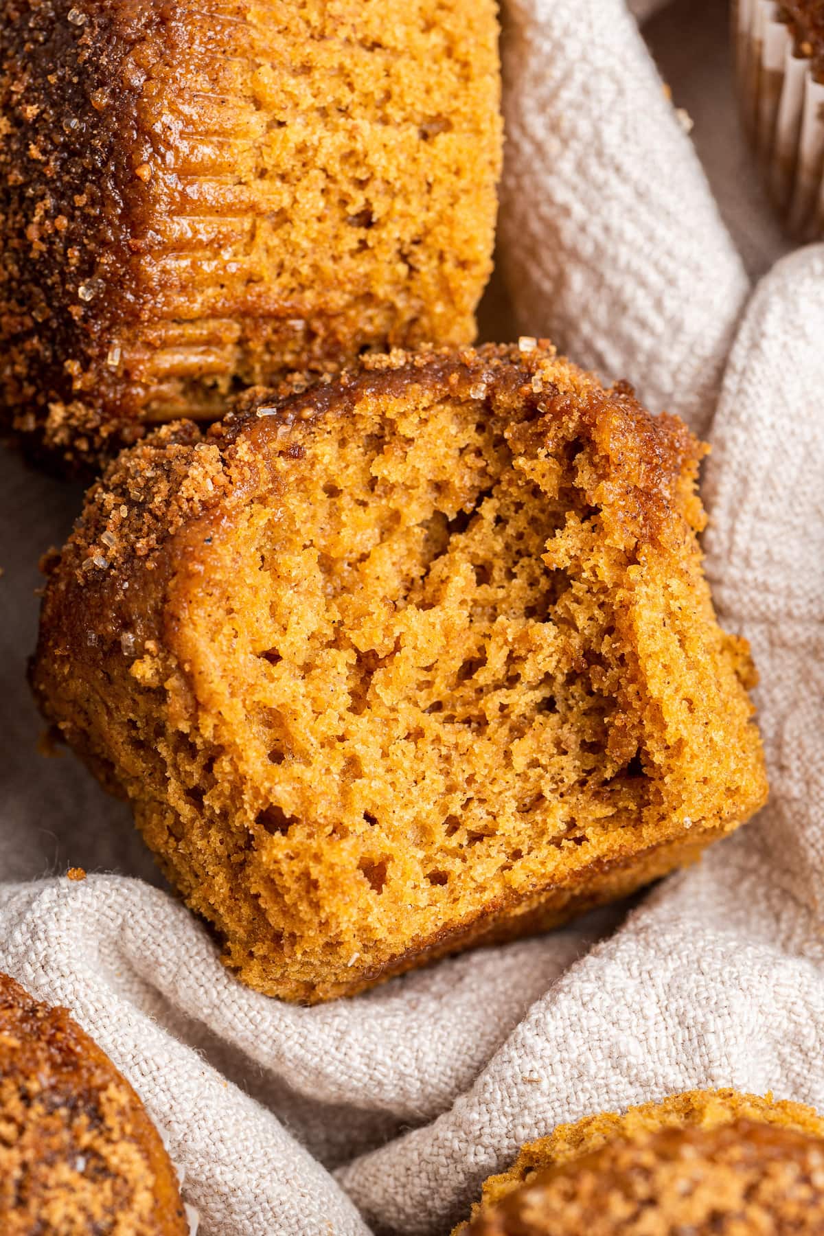 A sweet potato muffin with a bite taken out of it.