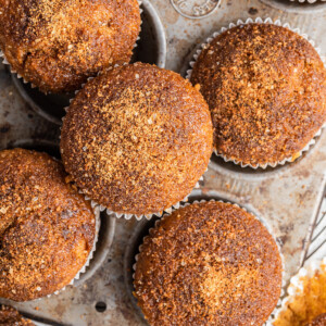 Sweet potato muffins in and around a muffin tin.