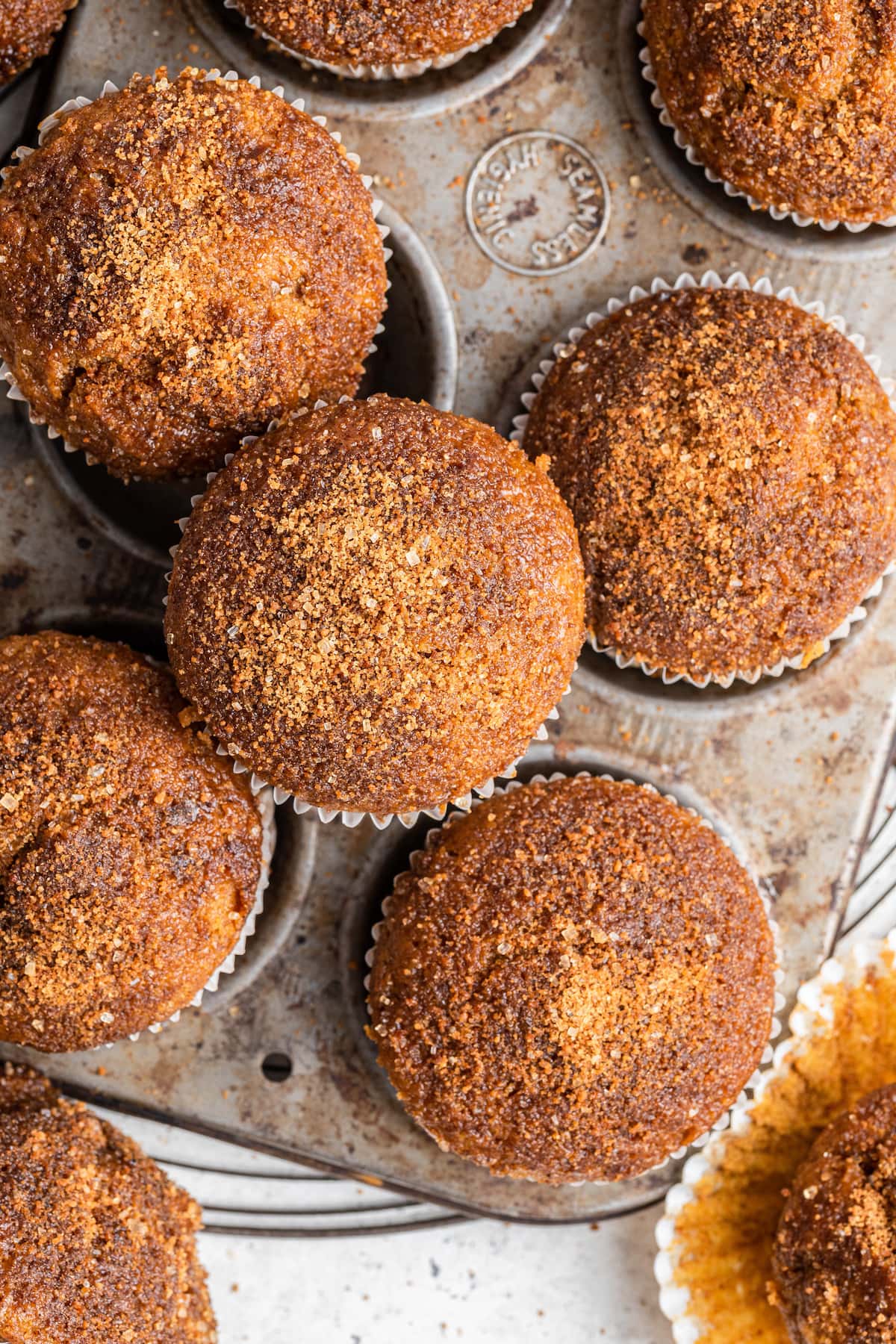 Sweet potato muffins in and around a muffin tin.