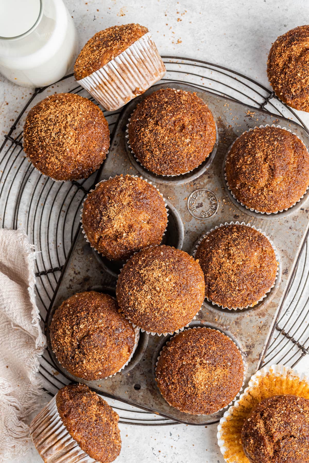 Sweet potato muffins in and around a muffin tin.