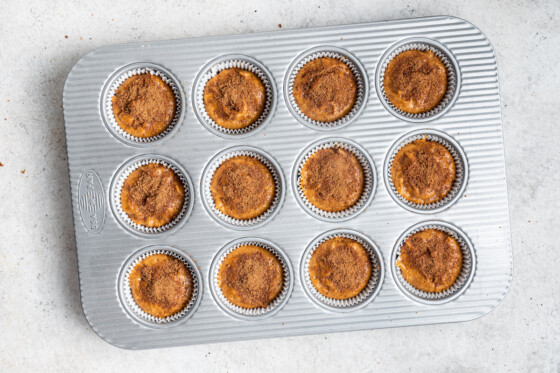 Twelve sweet potato muffins in a muffin tin before being baked.