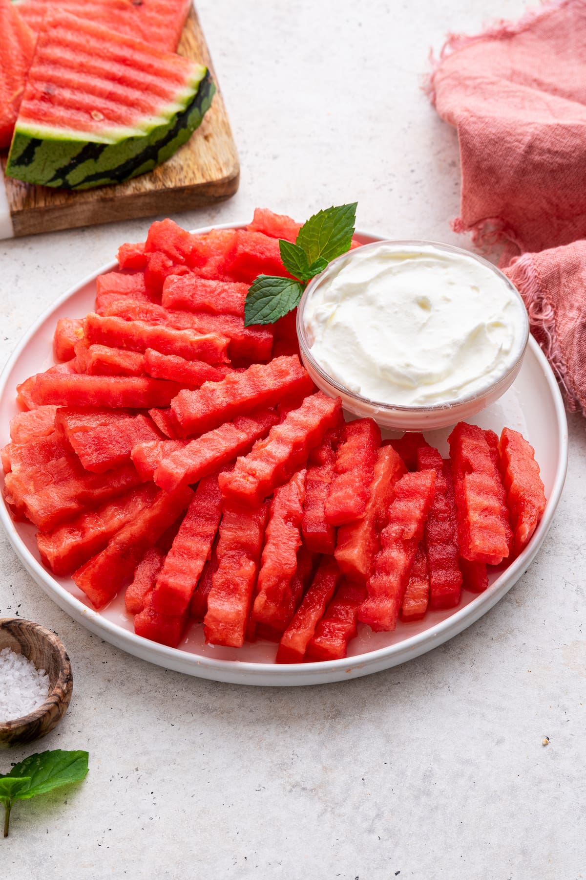 A plate of watermelon fries served with a yogurt dip.