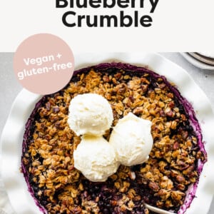 Photo of a blueberry crumble topped with three scoops of ice cream.