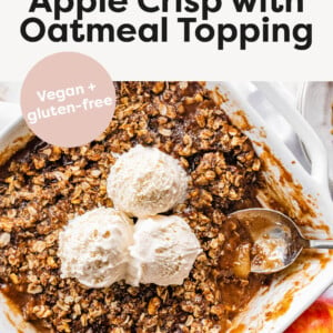 Apple crisp in a baking dish topped with scoops of ice cream.