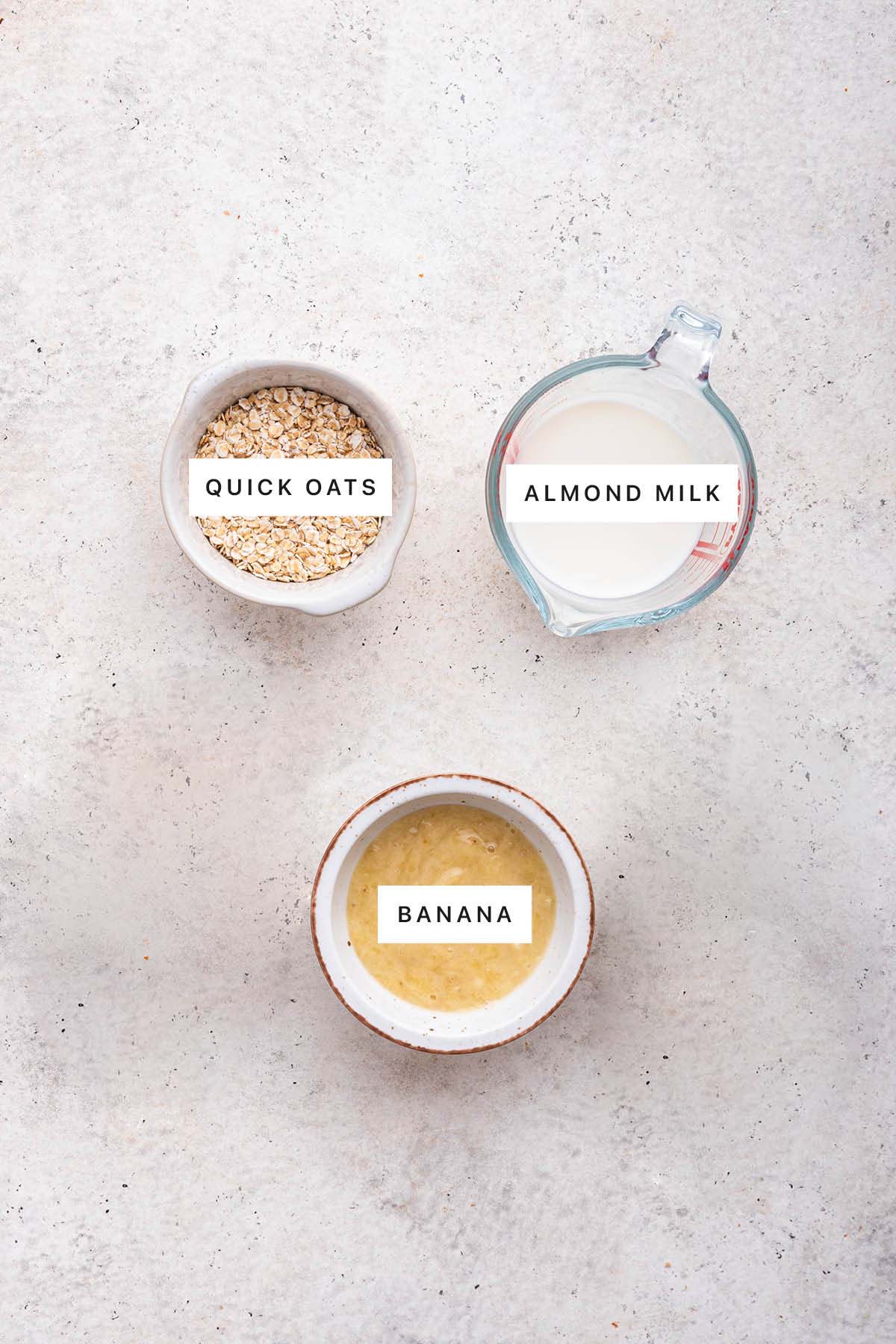 Ingredients measured out to make Oatmeal Fingers: quick oats, almond milk and banana.