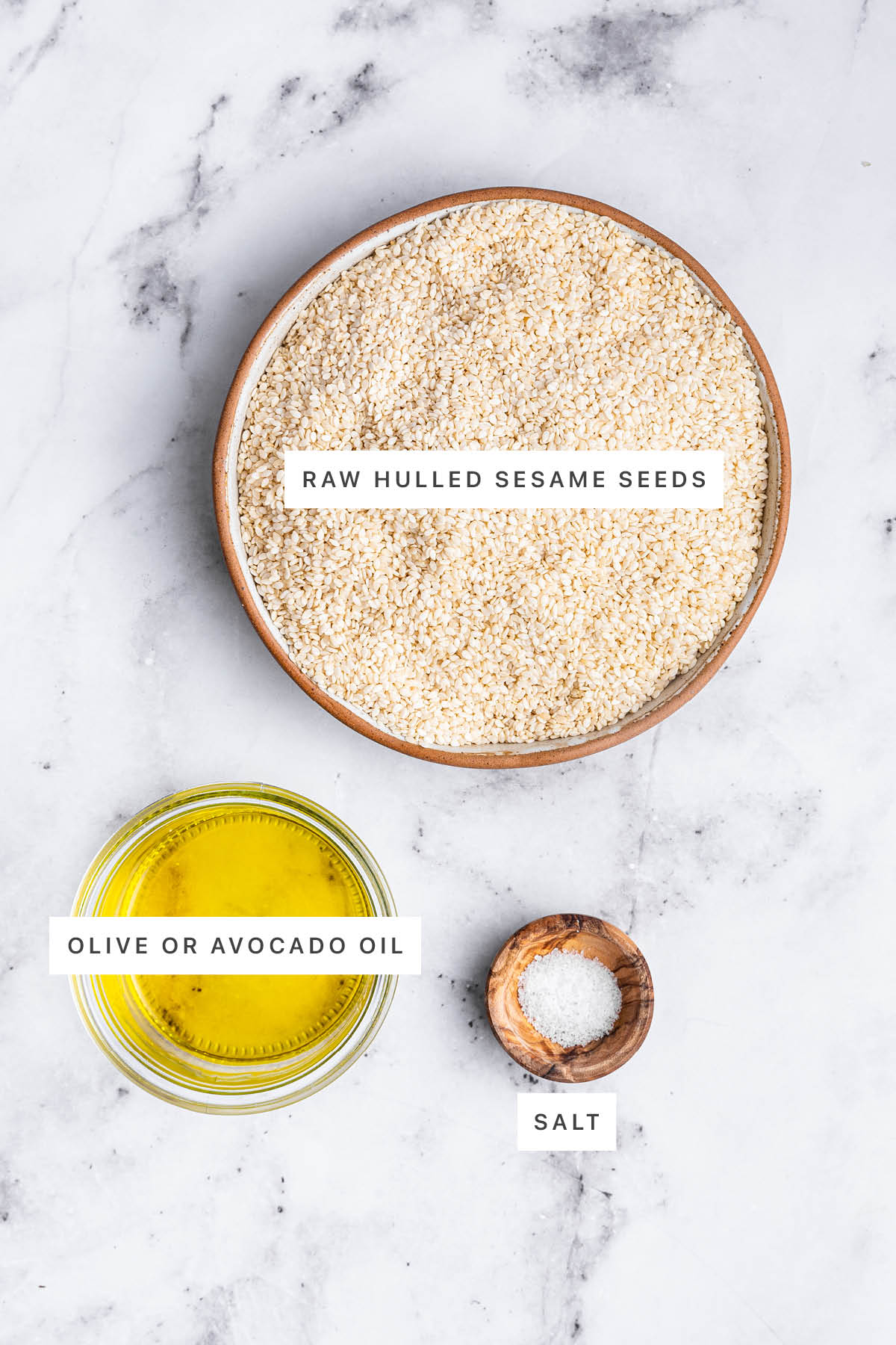 Ingredients measured out to make tahini: sesame seeds, olive oil and salt.