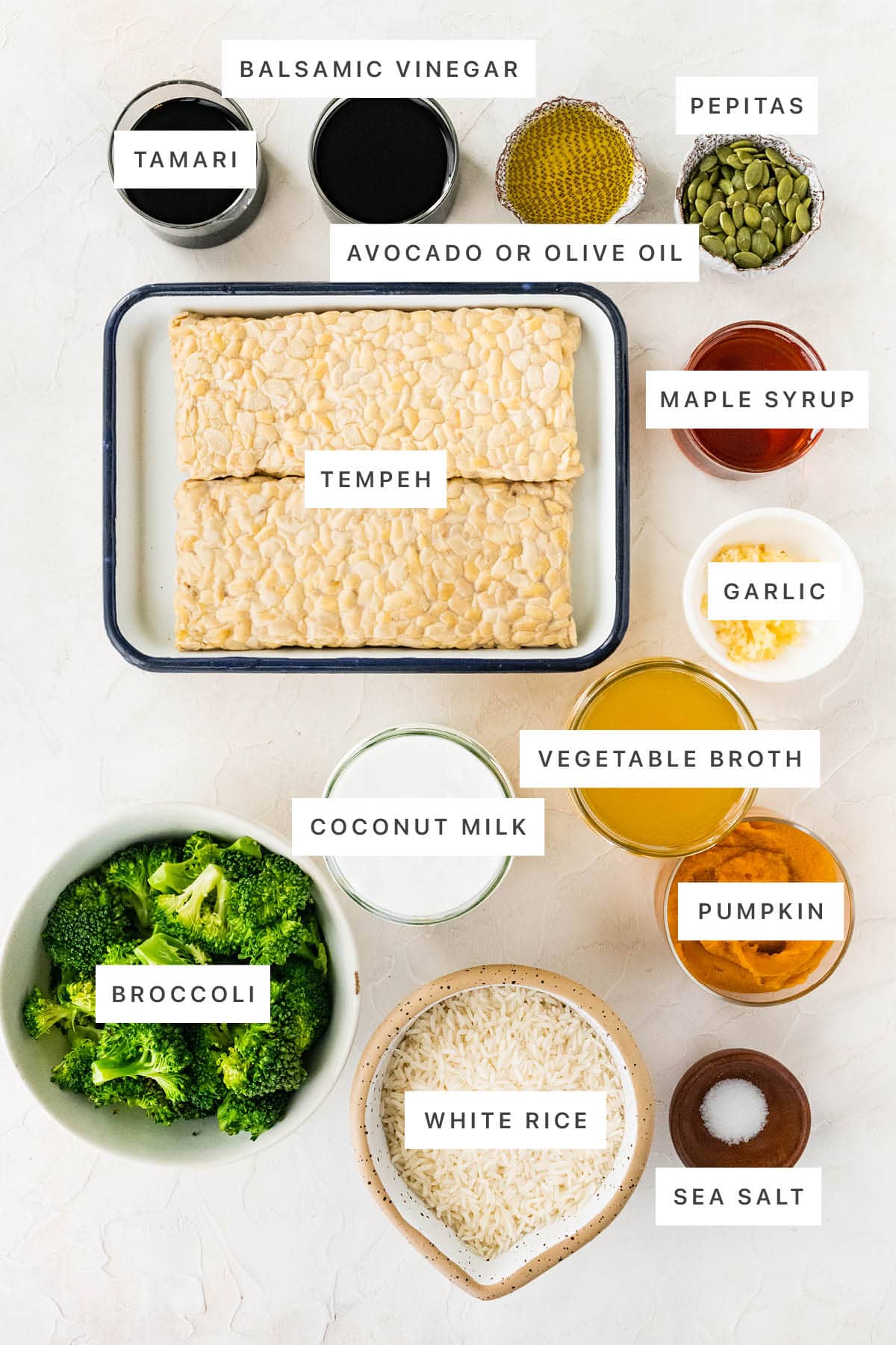 Ingredients measured out to make Maple Balsamic Tempeh Bowls: tamari, balsamic vinegar, olive oil, pepitas, tempeh, maple syrup, garlic, vegetable broth, coconut milk, pumpkin, broccoli, white rice and sea salt.