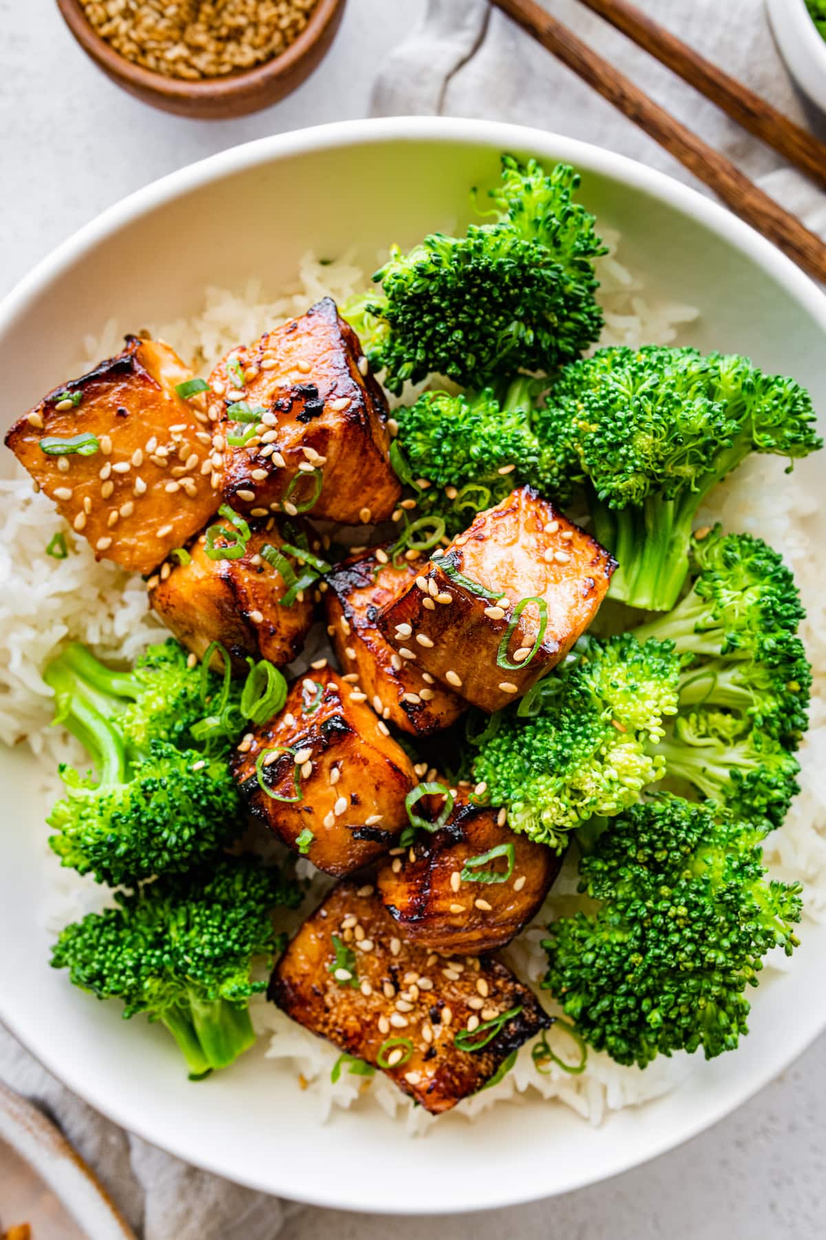 Air fryer salmon bites in a bowl with broccoli and rice.