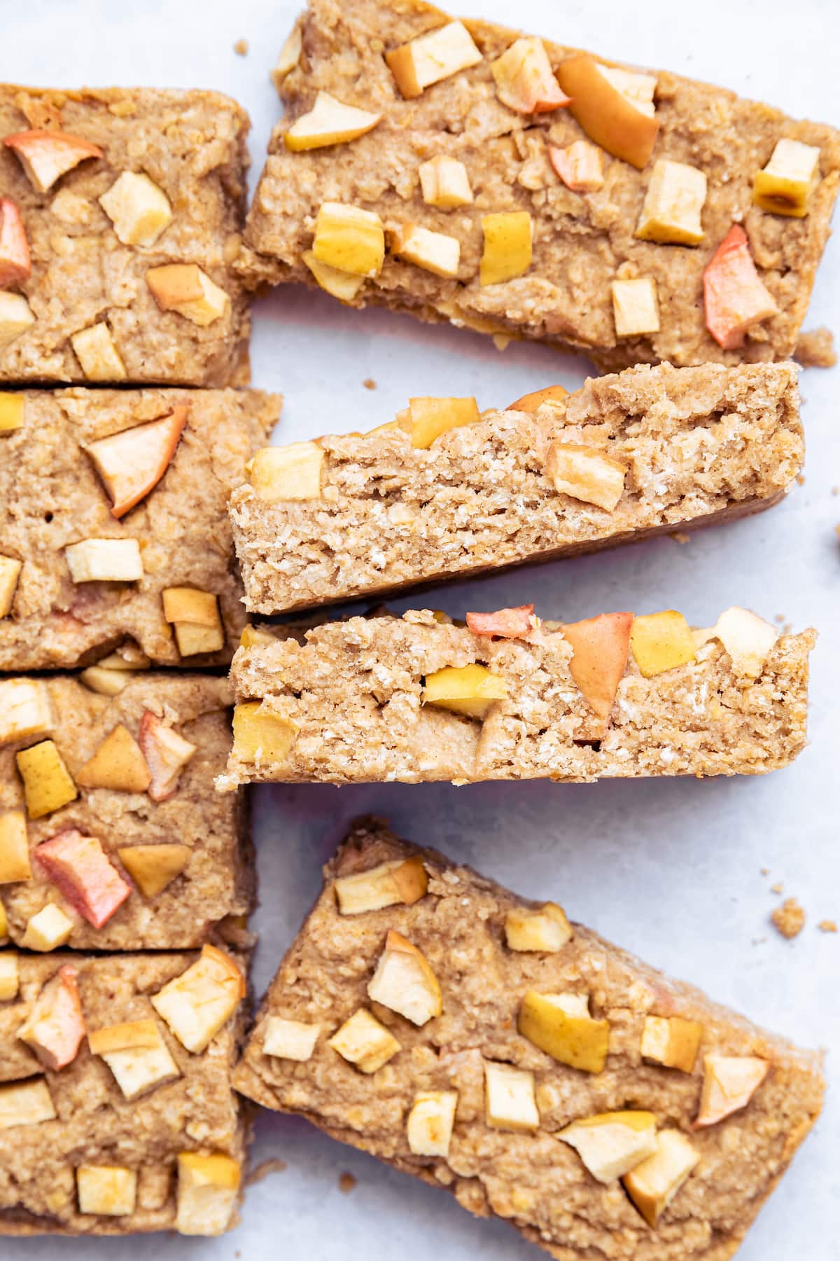8 apple oatmeal bars spread out with 2 on their side.