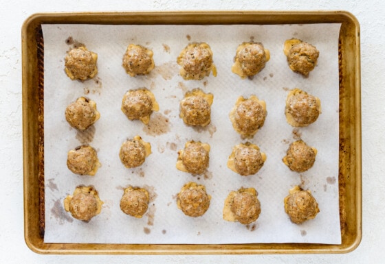 A baking tray with turkey meatballs after being baked in the oven.