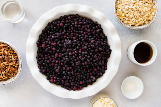 A pie dish full of blueberries.