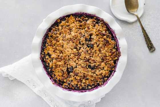 Blueberry crumble after being baked in a pie dish.