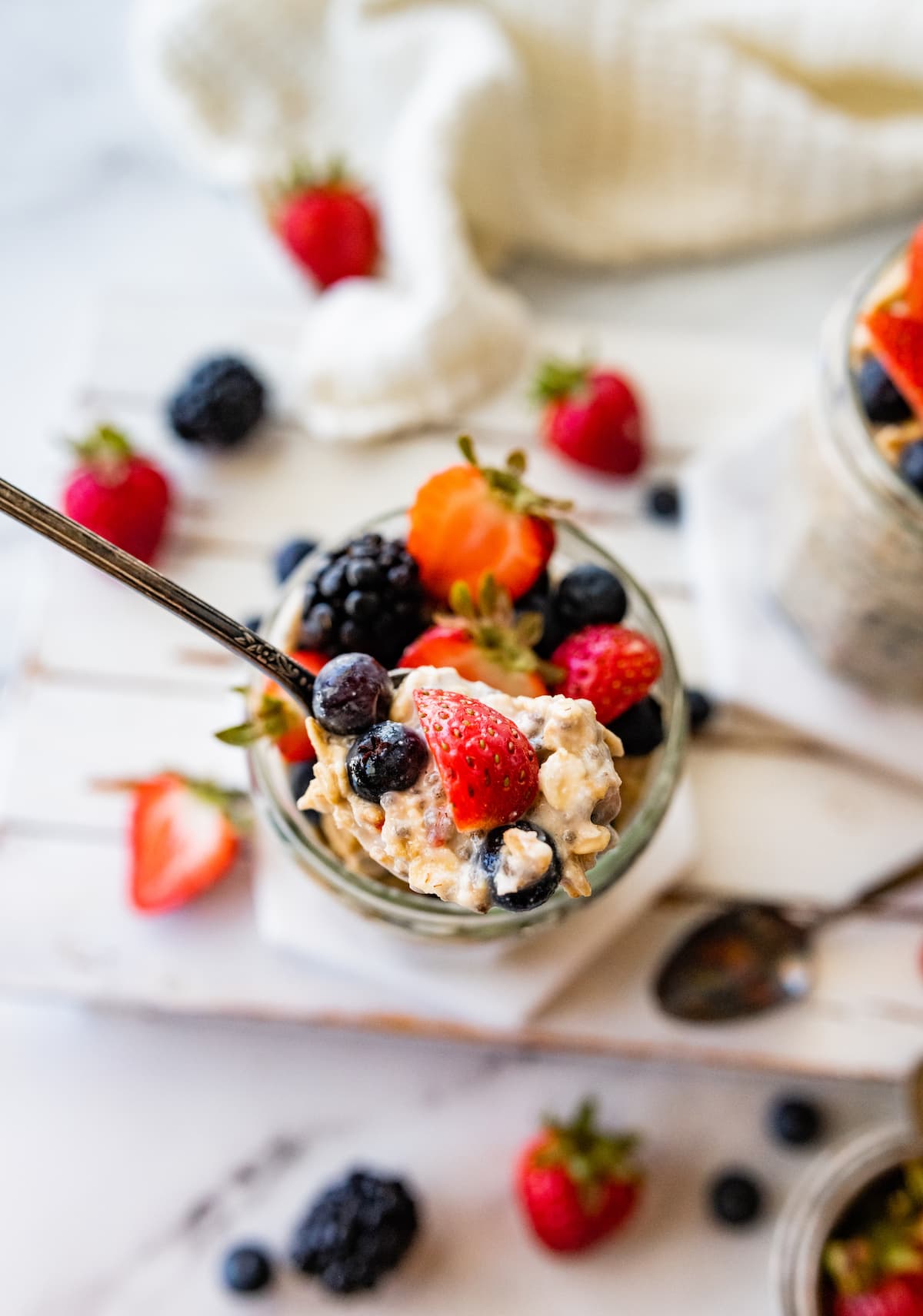 A spoonful of cottage cheese overnight oats with fresh berries.