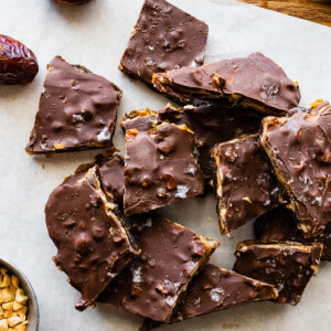 Multiple pieces of date bark on parchment paper.