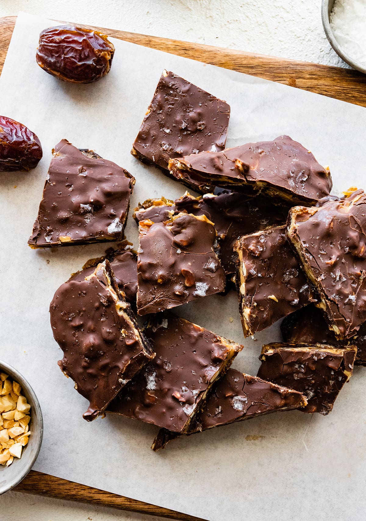 Multiple pieces of date bark on parchment paper.