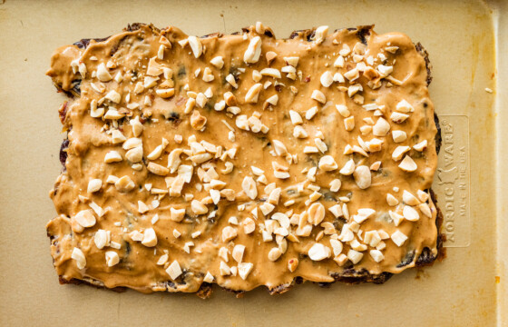 Peanut butter spread on top of the flattened dates and topped off with crushed peanuts.