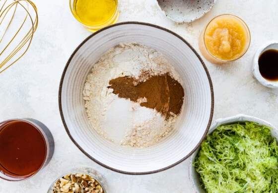 A mixing bowl with the dry ingredients for the healthy zucchini bread.