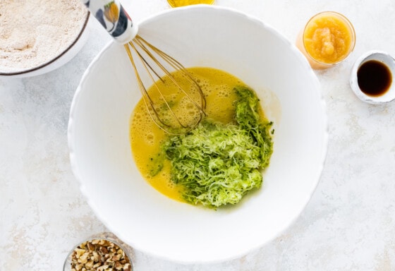 A mixing bowl with the wet ingredients for the healthy zucchini bread.