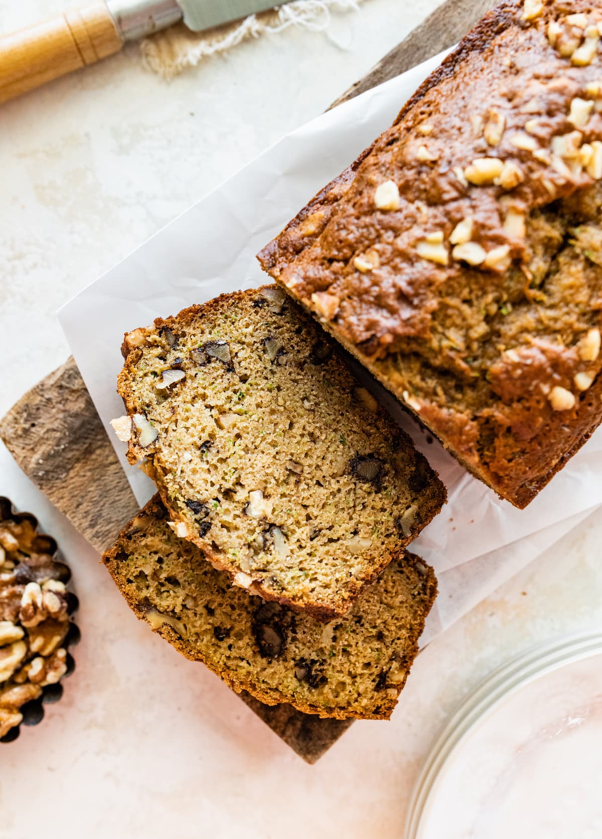 The healthy zucchini bread on a cutting board with two slices.