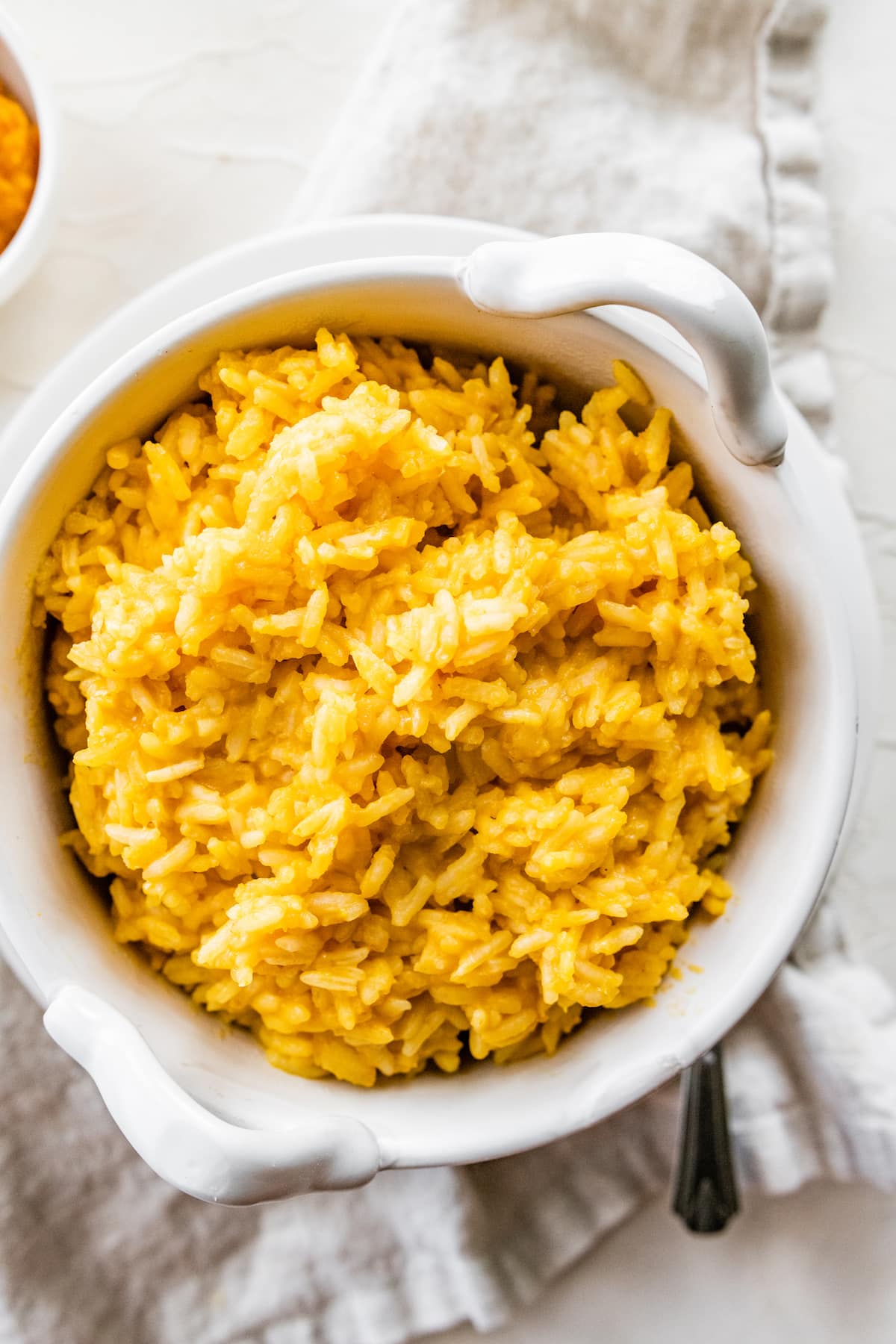 Pumpkin rice in a white bowl.