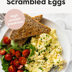 Cottage Cheese Scrambled Eggs on a plate with a salad and toast.