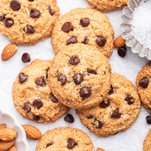 Multiple almond flour chocolate chip cookies on parchment paper.