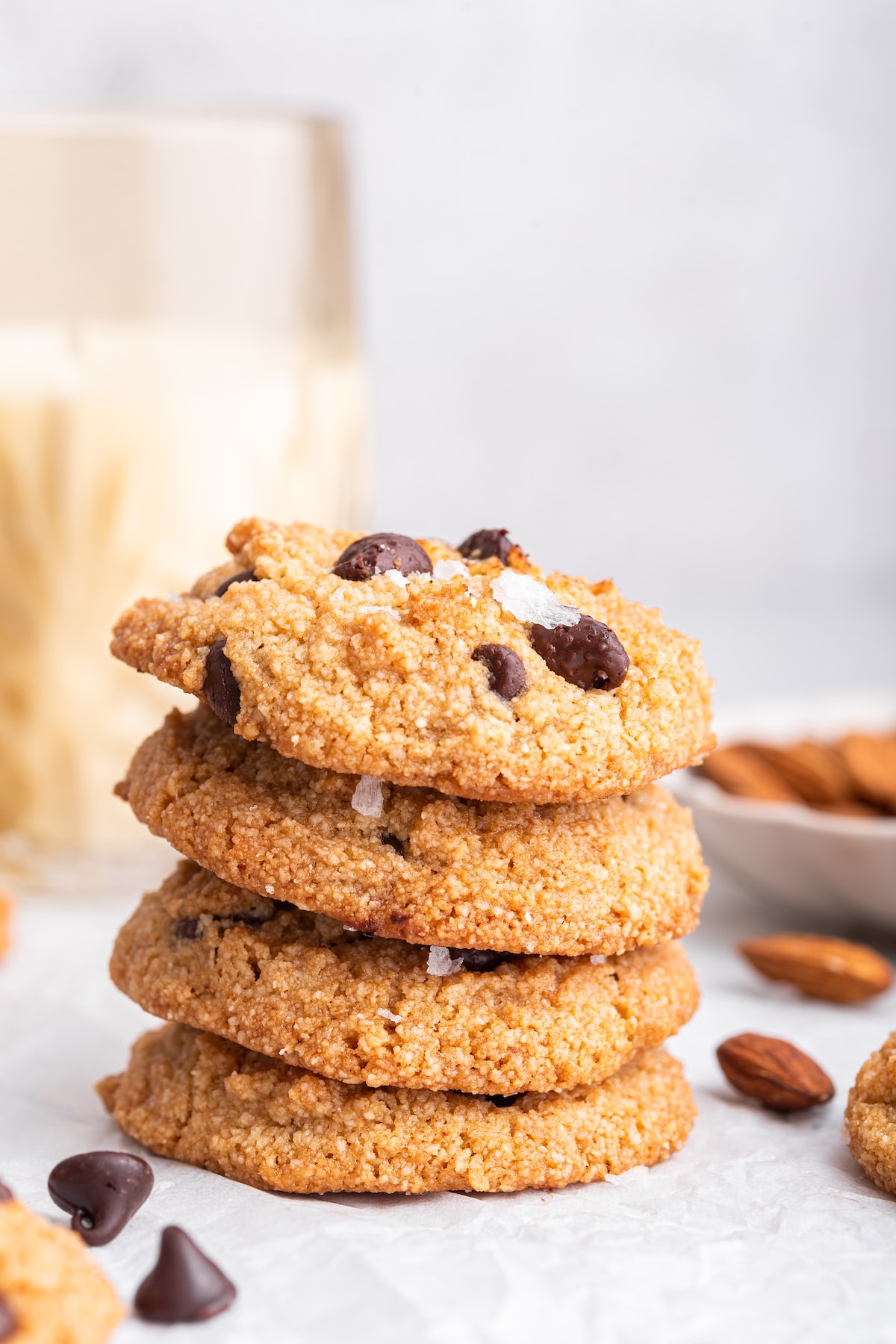 Four almond flour chocolate chip cookies stacked on one another.