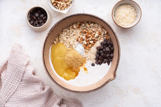 All the ingredients in a large mixing bowl for the almond joy baked oatmeal.