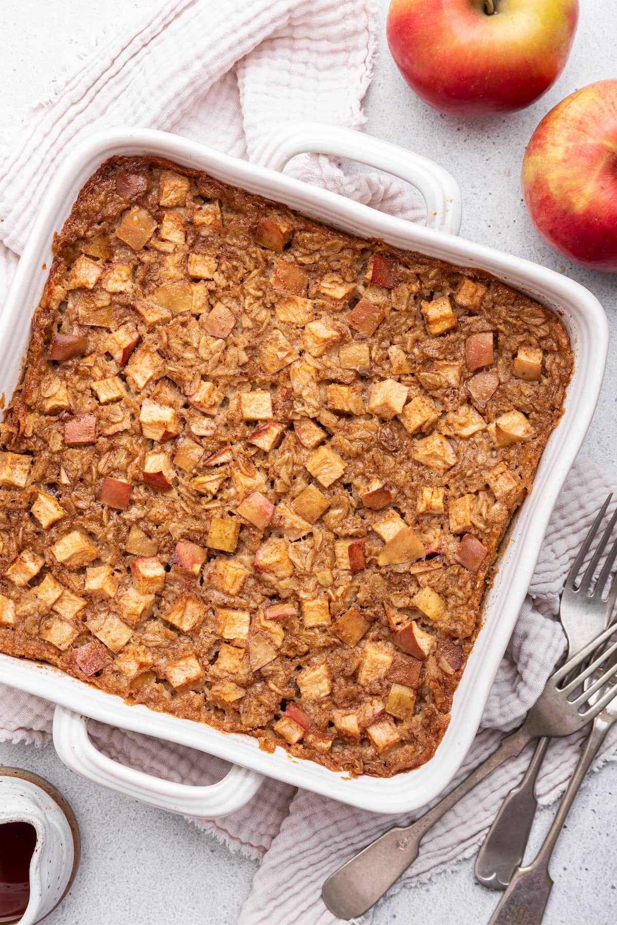 Apple cinnamon baked oatmeal in a square baking dish.