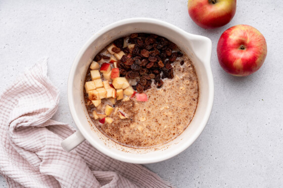 All the ingredients for the apple cinnamon baked oatmeal combined in a large mixing bowl.