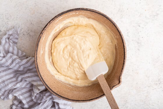 The wet and dry ingredients for the cottage cheese pancakes combined in a large mixing bowl to create the batter.