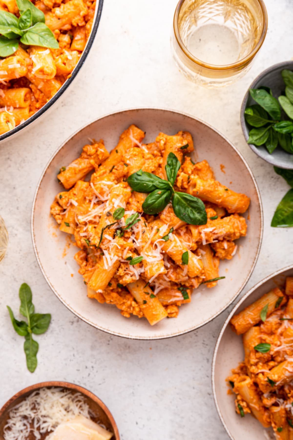 Cottage cheese pasta garnished with fresh basil and parmesan cheese in a bowl.