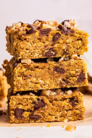 Three pumpkin oatmeal bars stacked on one another.