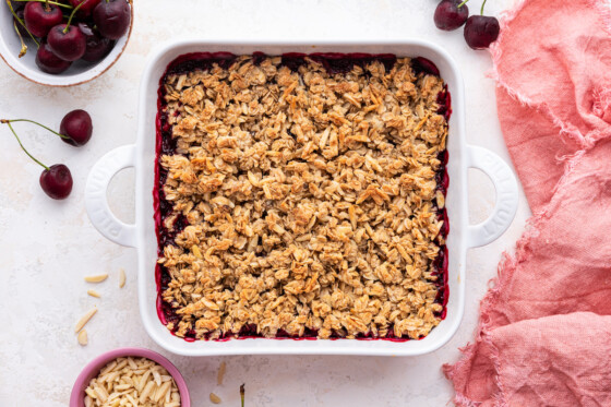 A finished cherry crisp in a square baking dish after being baked in the oven.