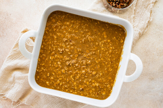 Pumpkin baked oatmeal batter added to a square baking dish.