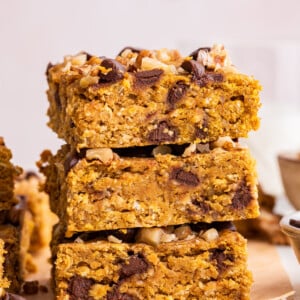 Three pumpkin oatmeal bars stacked on one another.