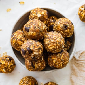 Many pumpkin protein balls in a small bowl.