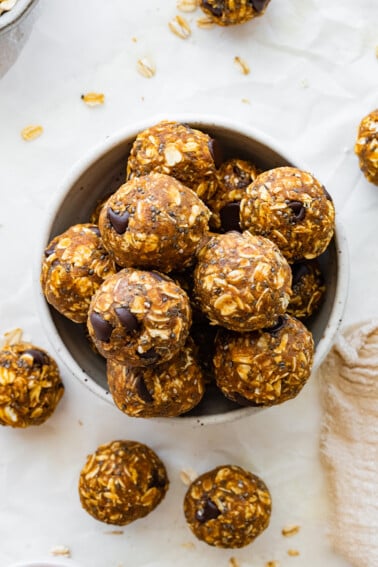Many pumpkin protein balls in a small bowl.