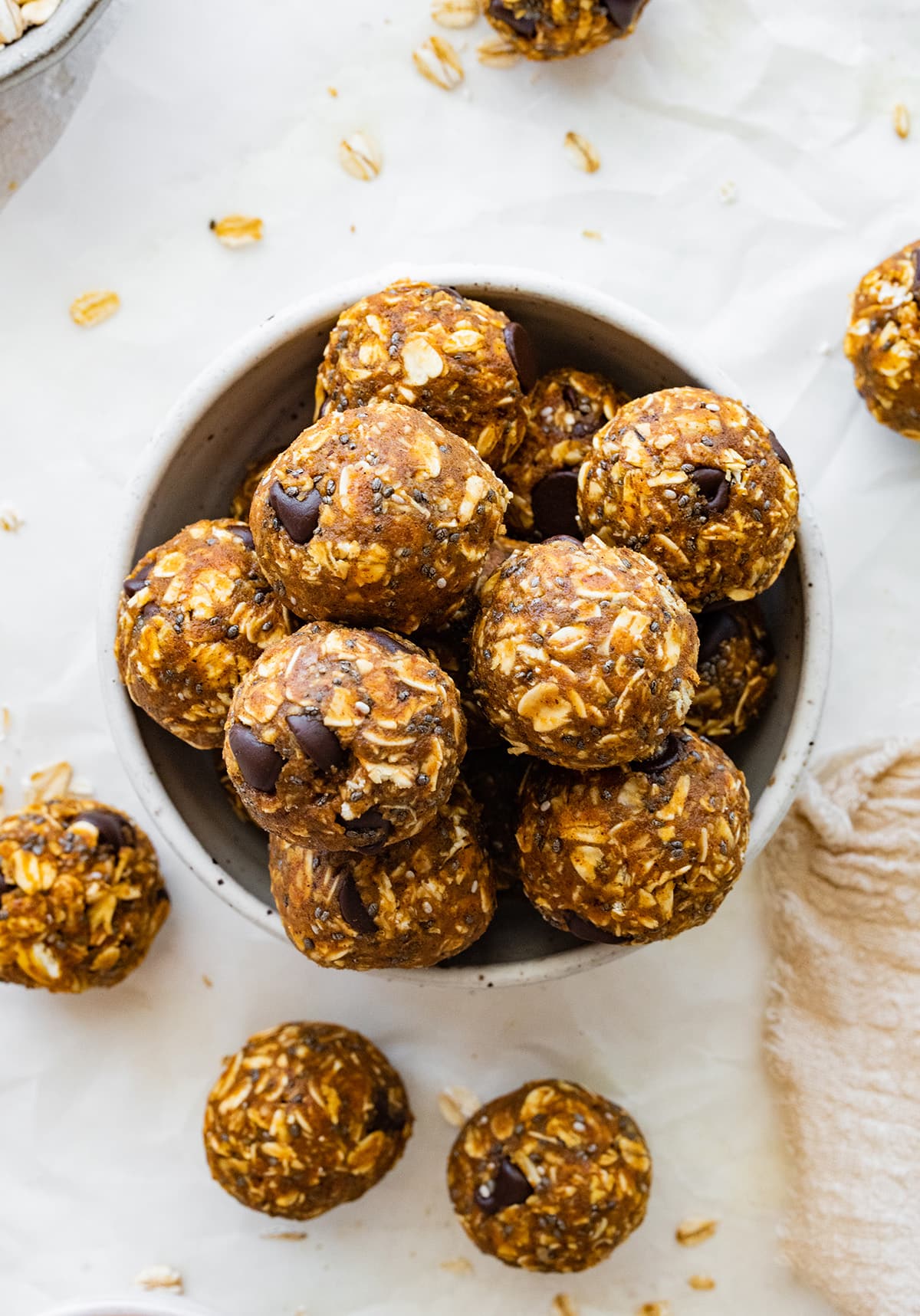 Many pumpkin protein balls in a small bowl.