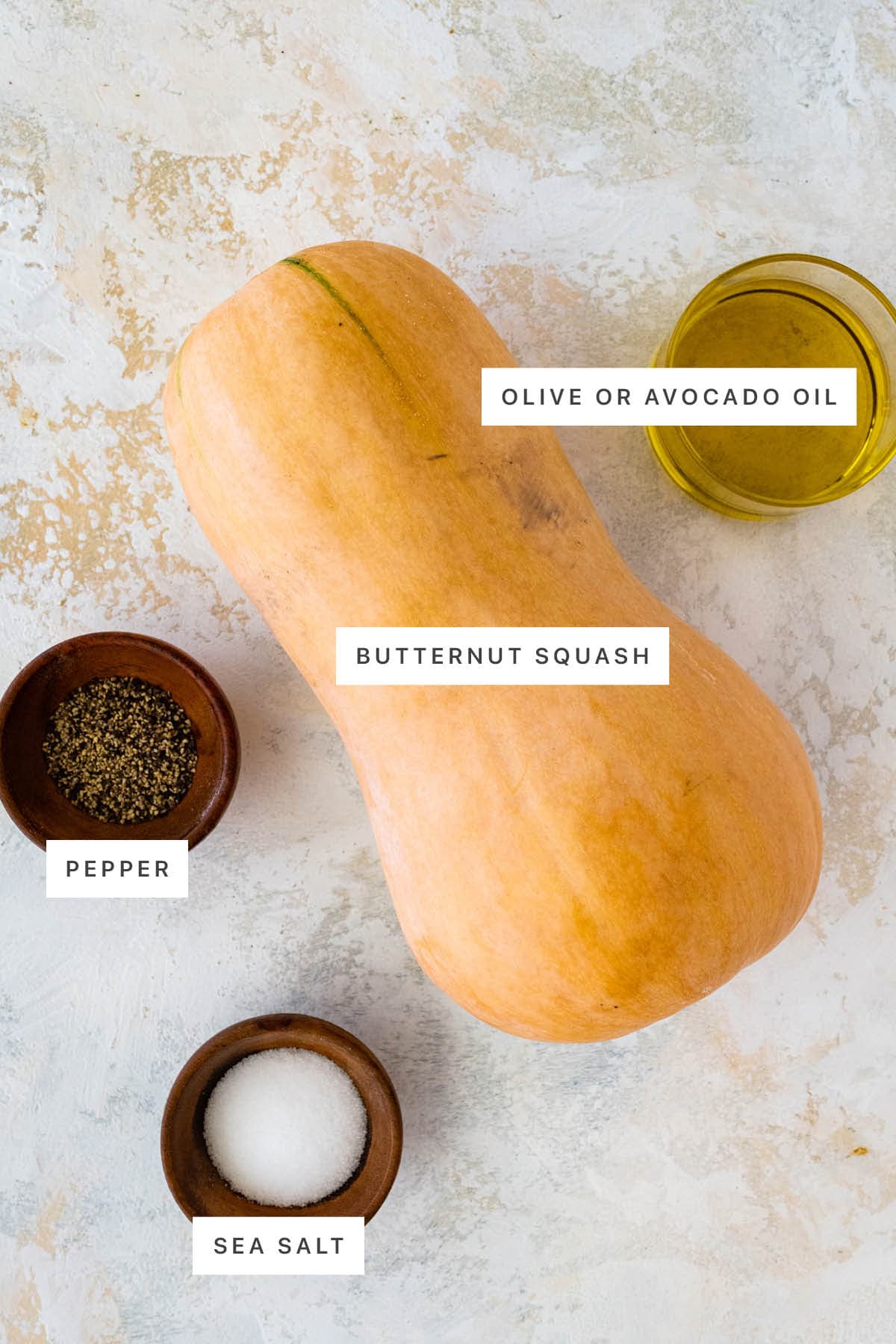 Ingredients measured out to make Air Fryer Butternut Squash: olive oil, butternut squash, pepper and sea salt.