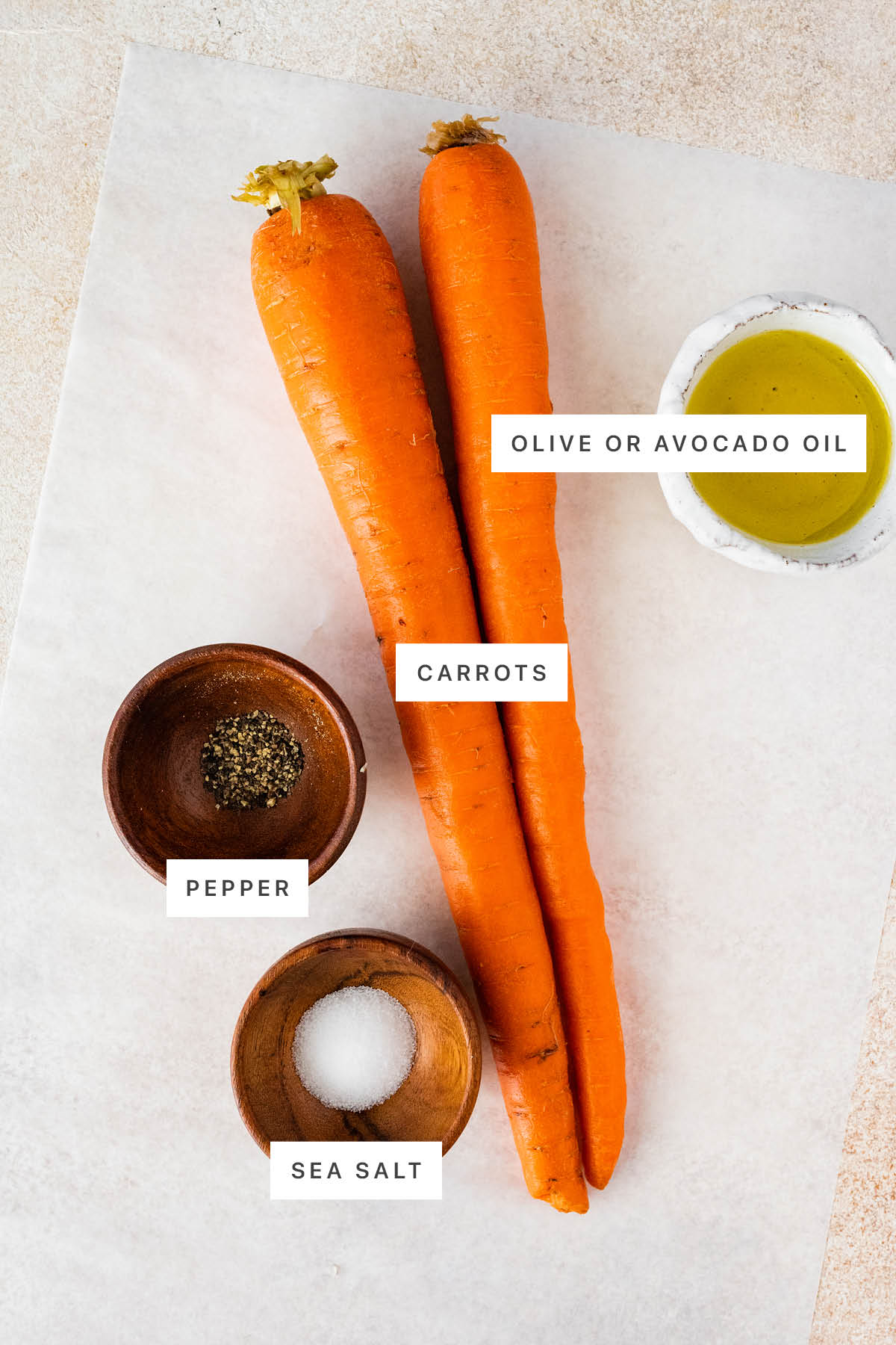 Ingredients measured out to make Air Fryer Carrots: olive oil, carrots, pepper and salt.